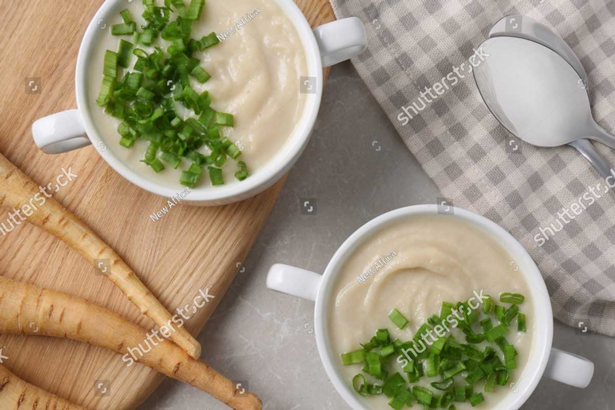 stock photo bowls with tasty creamy soup of parsnip served on light grey table flat lay 2247038045